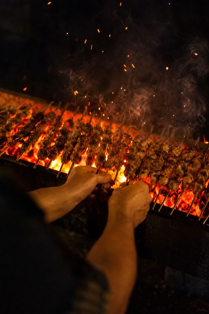 Grill cook working the charcoal at Chuan Bar 2088